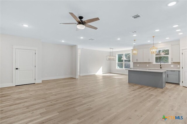 505 E Convent St, Victoria, TX 77901 - kitchen featuring a kitchen island, light countertops, ceiling fan, recessed lighting, and healthy amount of natural light