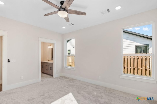505 E Convent St, Victoria, TX 77901 - unfurnished bedroom with baseboards, light colored carpet, connected bathroom, recessed lighting, and ceiling fan