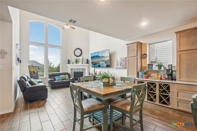 1640 Buckner Pl, San Antonio, TX 78253 - dining room featuring a tile fireplace, ceiling fan, and a high ceiling