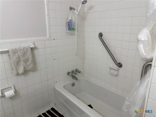 908 Randa St, Copperas Cove, TX 76522 - bathroom featuring tile walls and shower / tub combo