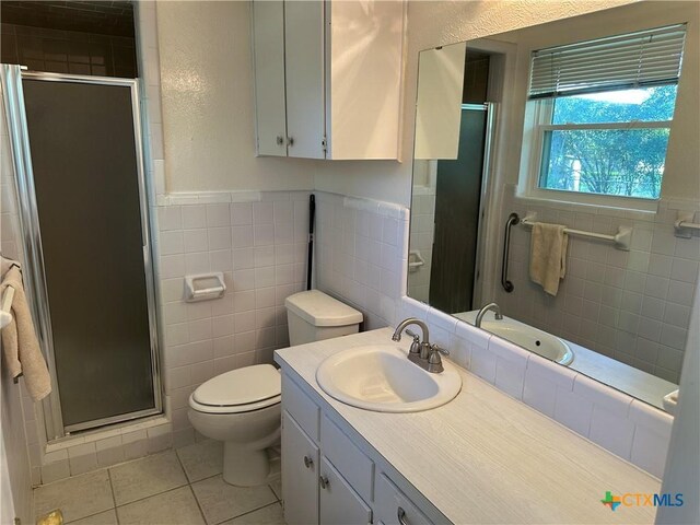 908 Randa St, Copperas Cove, TX 76522 - bathroom featuring tile patterned flooring, a stall shower, and tile walls