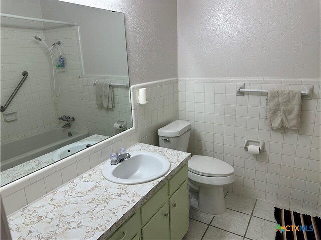 908 Randa St, Copperas Cove, TX 76522 - bathroom featuring shower / bathing tub combination, tile walls, vanity, toilet, and a textured wall