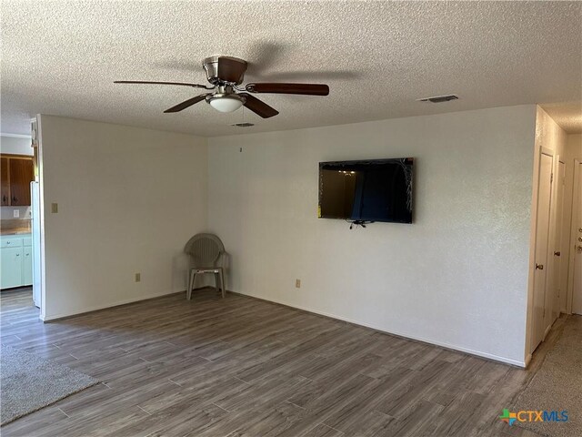 908 Randa St, Copperas Cove, TX 76522 - unfurnished living room with a ceiling fan, a textured ceiling, visible vents, and wood finished floors