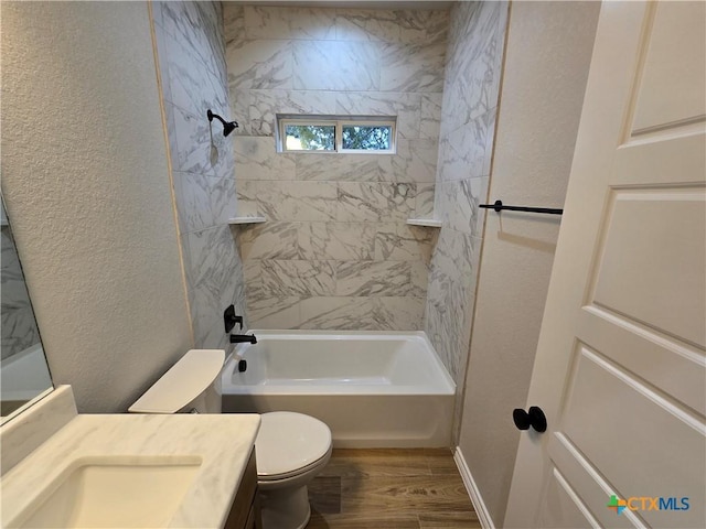 full bathroom with tiled shower / bath, toilet, vanity, and hardwood / wood-style flooring