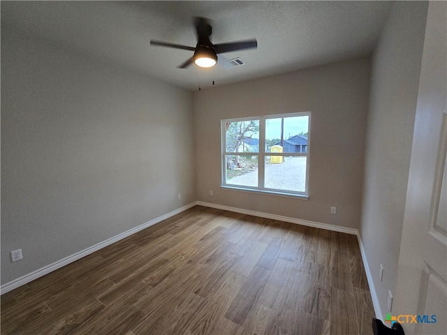 unfurnished room featuring hardwood / wood-style floors and ceiling fan