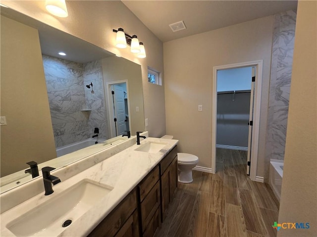 bathroom with hardwood / wood-style floors, vanity, and toilet