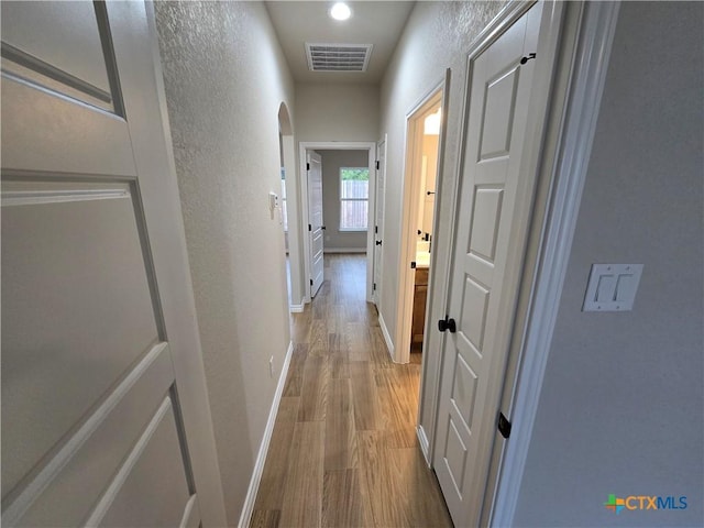 hallway with wood-type flooring