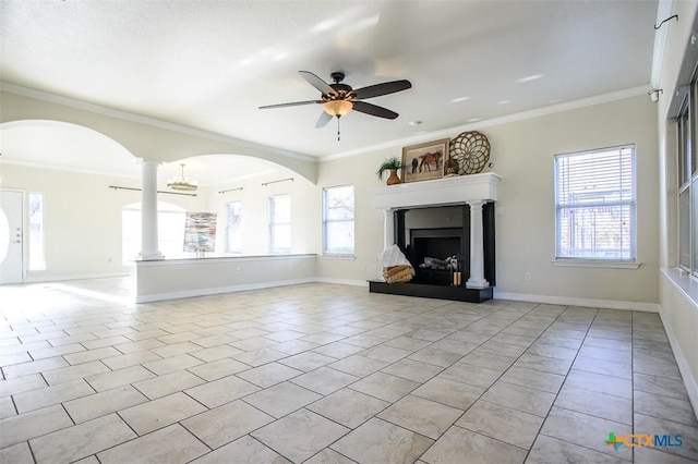 unfurnished living room with light tile patterned floors, a fireplace with raised hearth, ornamental molding, and plenty of natural light