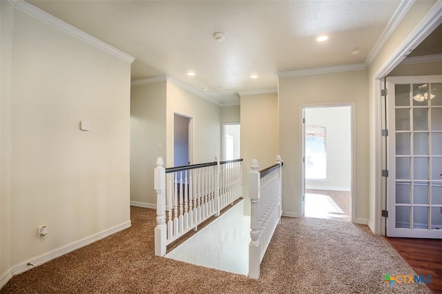 corridor with ornamental molding, baseboards, and an upstairs landing