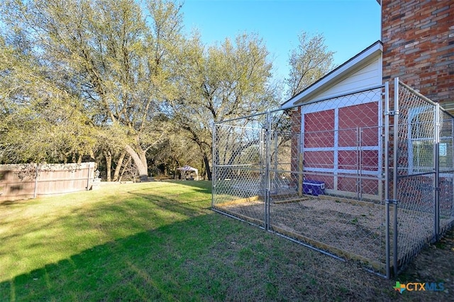 view of yard with fence and an outbuilding