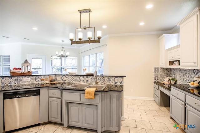 kitchen with decorative light fixtures, a notable chandelier, gray cabinets, stainless steel dishwasher, and a sink