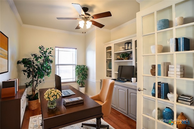 office space with dark wood-style floors, ornamental molding, and a ceiling fan