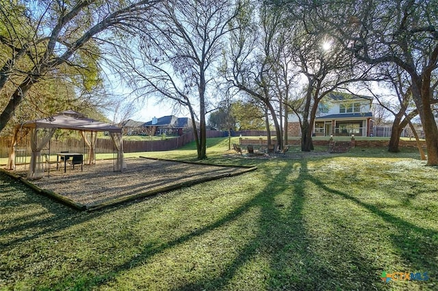 view of yard featuring fence and a gazebo