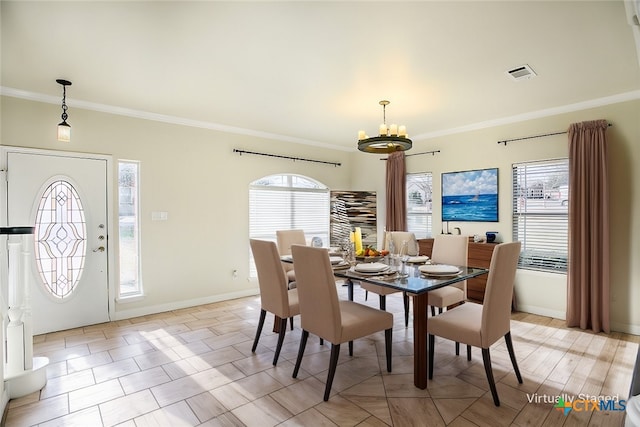 dining space with baseboards, visible vents, a chandelier, and crown molding