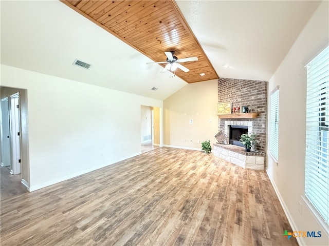 3434 Horizon St, Copperas Cove, TX 76522 - unfurnished living room featuring vaulted ceiling, a brick fireplace, wood finished floors, and visible vents