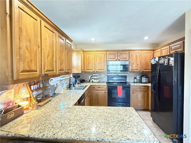 3434 Horizon St, Copperas Cove, TX 76522 - kitchen with backsplash, a sink, black appliances, a peninsula, and light tile patterned flooring