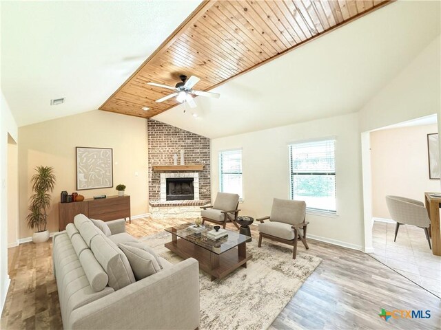 3434 Horizon St, Copperas Cove, TX 76522 - living room featuring light wood-style floors, a brick fireplace, a ceiling fan, baseboards, and vaulted ceiling