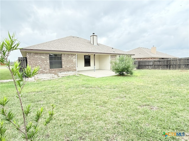 3434 Horizon St, Copperas Cove, TX 76522 - back of property with a chimney, brick siding, fence, a yard, and a patio