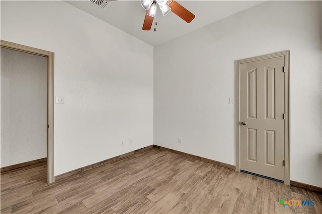 spare room featuring ceiling fan and light hardwood / wood-style floors