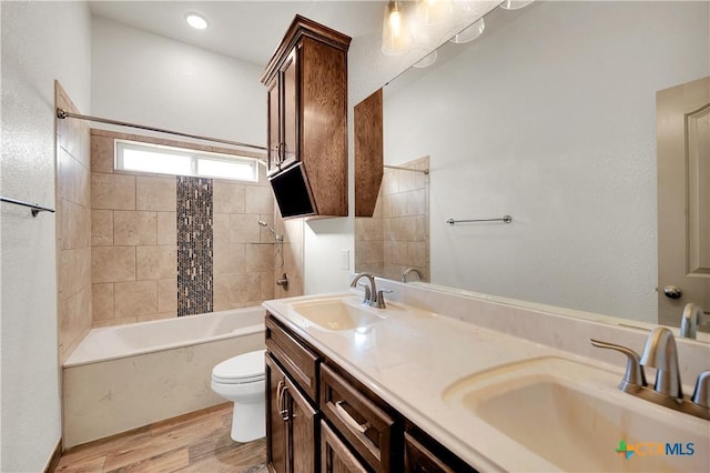 full bathroom with vanity, wood-type flooring, shower / bath combo, and toilet