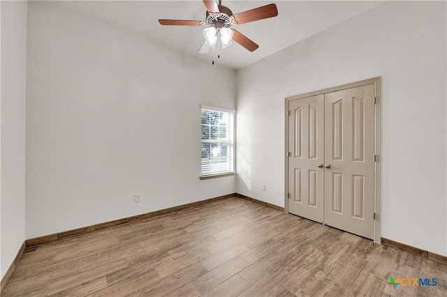 unfurnished bedroom with light wood-type flooring, a closet, and ceiling fan