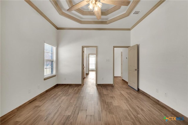 empty room with ceiling fan, crown molding, and light hardwood / wood-style flooring