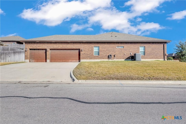 single story home with a front yard, a garage, and cooling unit