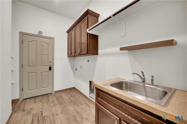 laundry room featuring sink, cabinets, light wood-type flooring, and hookup for an electric dryer