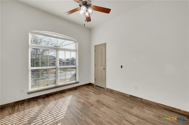 empty room with ceiling fan and light hardwood / wood-style floors