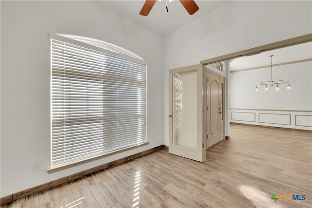 spare room with light wood-type flooring and ceiling fan