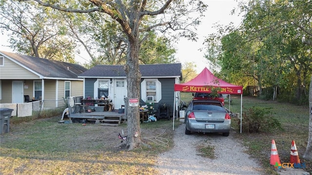 ranch-style home featuring a carport and a deck