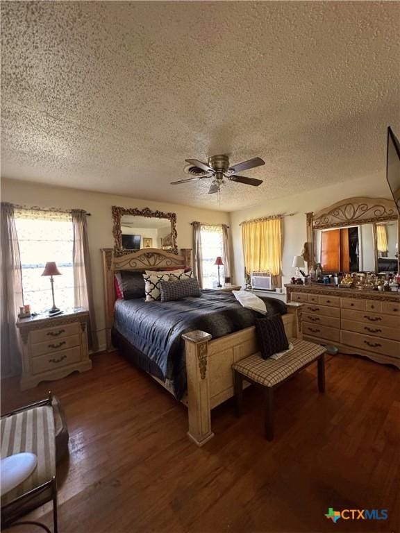 bedroom featuring a ceiling fan, a textured ceiling, and wood finished floors