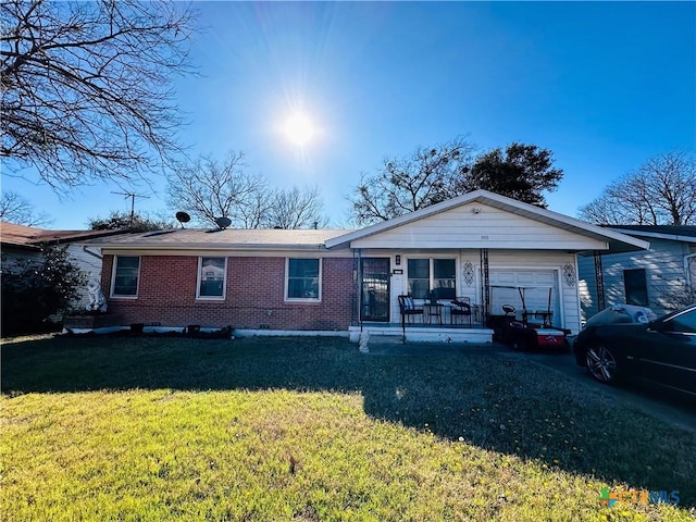 view of front of home featuring covered porch, a front lawn, brick siding, and a garage