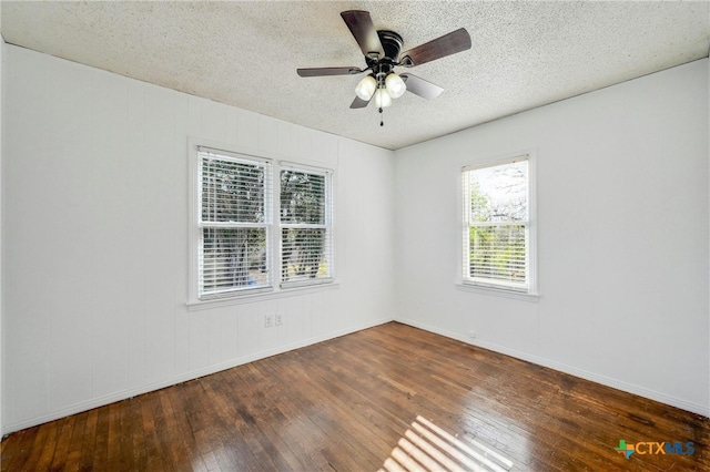 spare room with ceiling fan, dark hardwood / wood-style flooring, and a textured ceiling