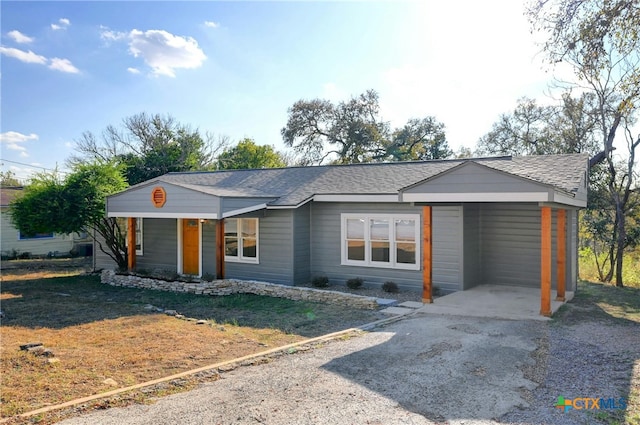 ranch-style house featuring a carport