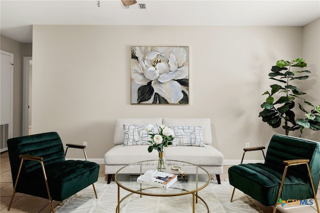 sitting room featuring visible vents, baseboards, and tile patterned floors