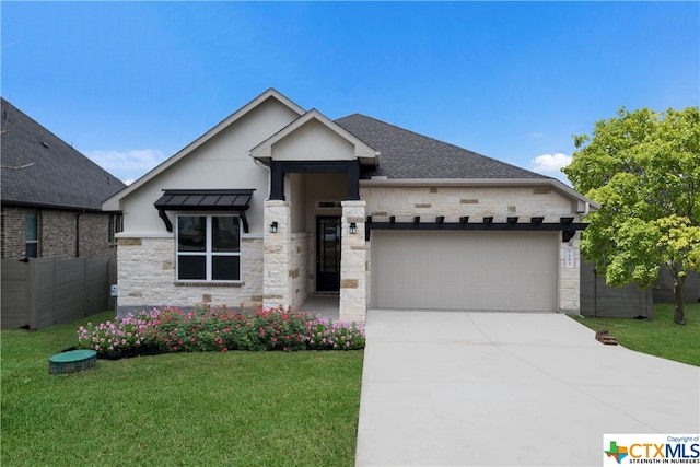 view of front of property featuring a garage and a front lawn