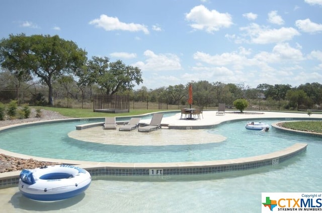 view of swimming pool with a patio area