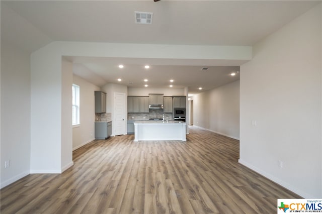 unfurnished living room featuring wood-type flooring