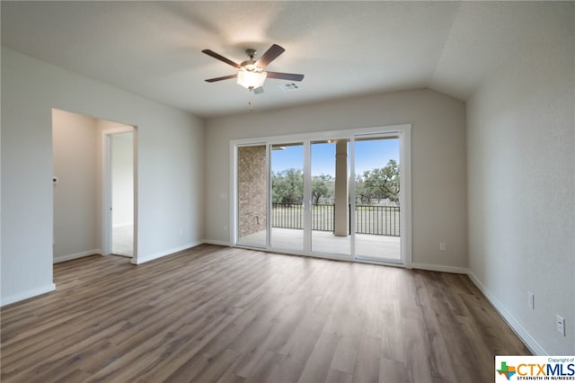 unfurnished room with dark hardwood / wood-style flooring, lofted ceiling, and ceiling fan