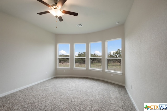 carpeted spare room with ceiling fan