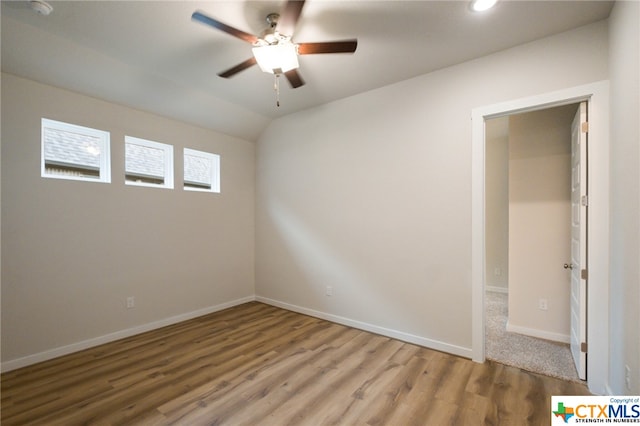 spare room with hardwood / wood-style floors and ceiling fan