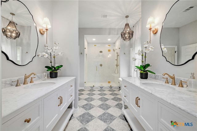 1660 W Mccarty Ln, San Marcos, TX 78666 - bathroom featuring a shower stall, two vanities, and tile patterned floors