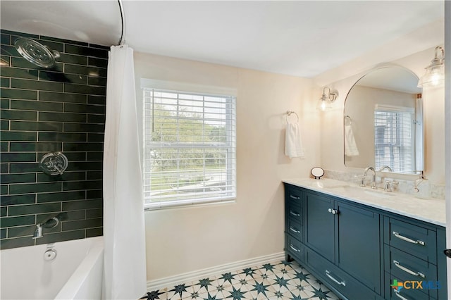 1660 W Mccarty Ln, San Marcos, TX 78666 - full bathroom with healthy amount of natural light, vanity, shower / bath combination with curtain, and baseboards
