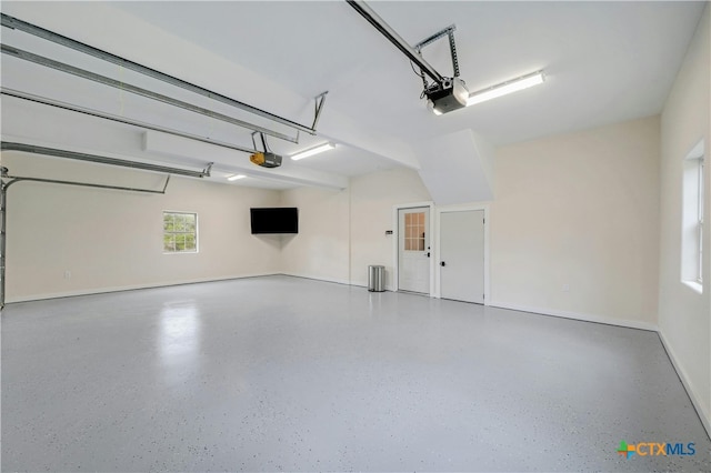 1660 W Mccarty Ln, San Marcos, TX 78666 - garage with a garage door opener and baseboards