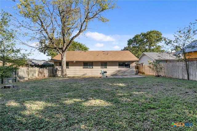 rear view of property with a yard