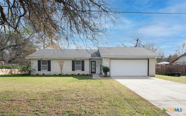 single story home featuring a front lawn and a garage