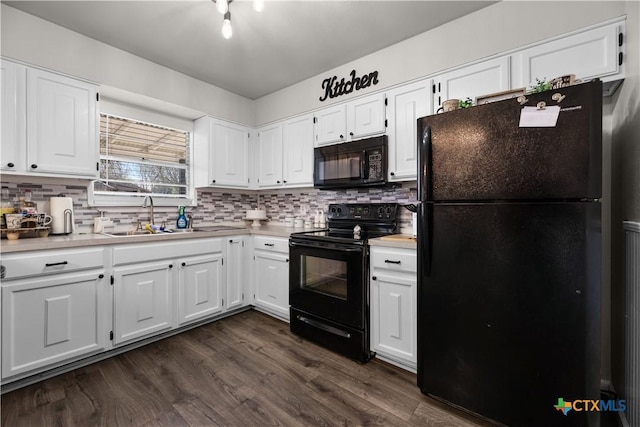 kitchen featuring black appliances, dark wood-type flooring, white cabinetry, tasteful backsplash, and sink