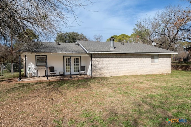 rear view of property with a lawn, french doors, and a patio