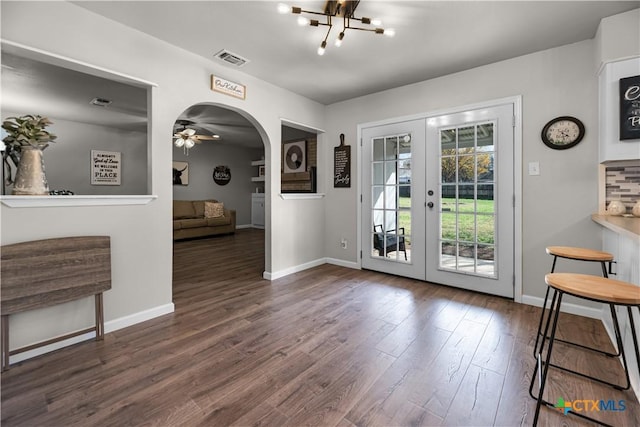 doorway featuring french doors, dark hardwood / wood-style flooring, and an inviting chandelier